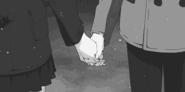 a man and a woman are holding hands in the snow .