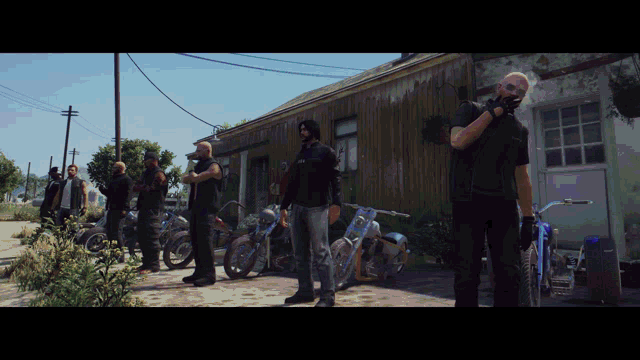 a group of men are standing in front of a building with motorcycles