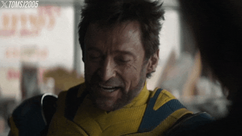 a close up of a man in a yellow and blue suit with toms 2005 on the bottom