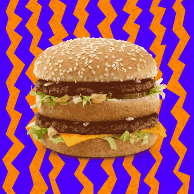 a hamburger with sesame seeds and lettuce on a purple and orange background
