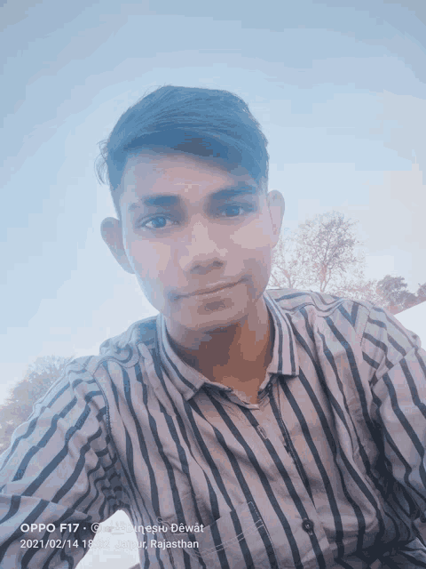 a young man taking a selfie with an oppo f17 phone