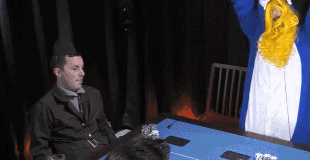 a man in a military uniform sits at a poker table while a man in a penguin costume stands behind him