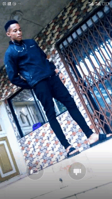 a man with a stethoscope around his neck is standing in front of a gate