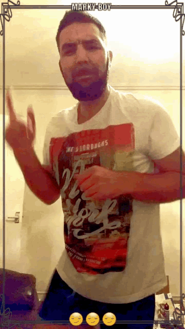 a man with a beard wearing a shirt that says marky boy on it