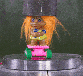 a troll doll with orange hair is riding a pink and green skateboard