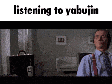 a man wearing headphones is listening to yabujin in a living room