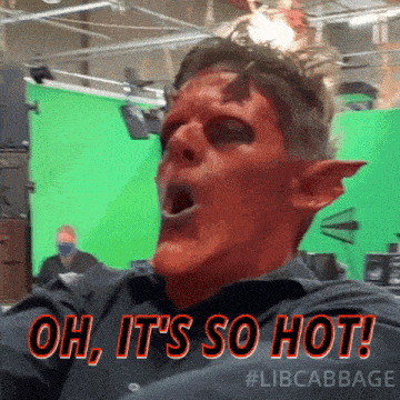 a man with red paint on his face says oh it 's so hot ..