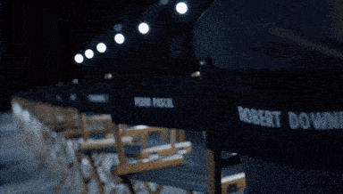 robert downey jr. is sitting in a directors chair
