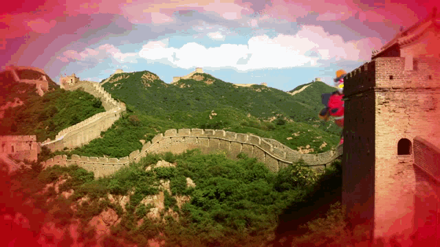 the great wall of china is surrounded by trees and mountains