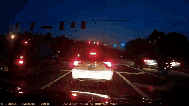 a car is driving down a highway at night with a sticker that says auto-vox 02pro