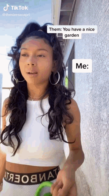 a woman in a white crop top is talking about having a nice garden ..