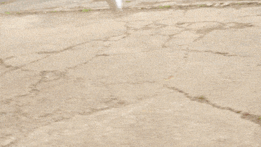 a blurry picture of a person in a robot costume running on the ground .