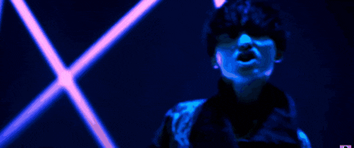 a pixelated image of a man in a purple jacket