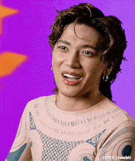 a man with a tattoo on his chest is making a funny face while wearing a pink shirt .