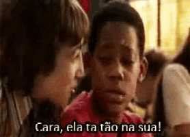 a boy in a red shirt is talking to another boy with the words cara ela ta tao na sua .