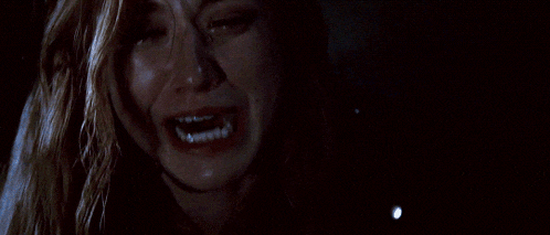 a woman is crying with her mouth wide open
