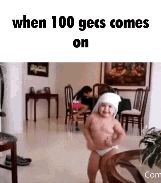 a baby in a diaper is dancing in a living room with the caption when 100 gecs comes on
