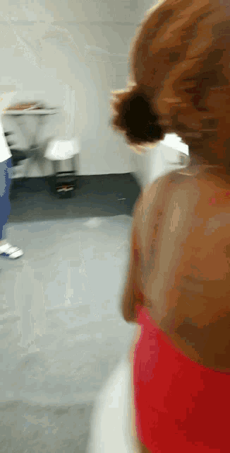 a blurry picture of a person in a red tank top