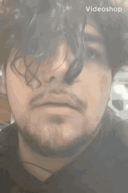 a close up of a man 's face with a videoshop watermark in the corner