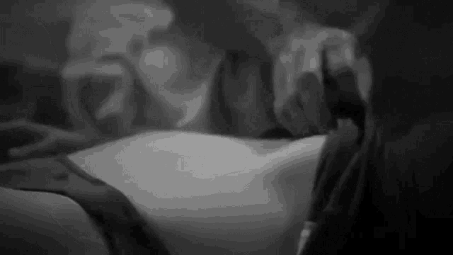 a black and white photo of a woman 's torso and breasts