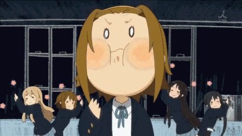 a group of anime girls are dancing in front of a building with a tbs logo on the bottom