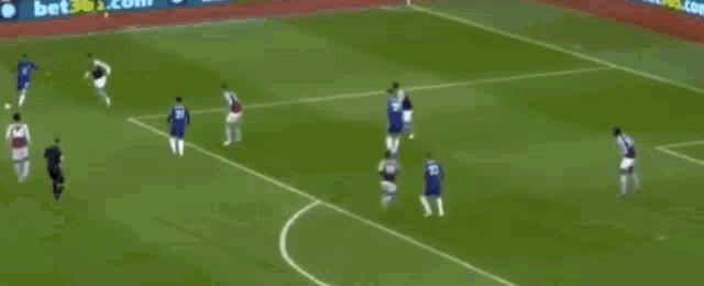 a blurry picture of a soccer game with ads for bet365