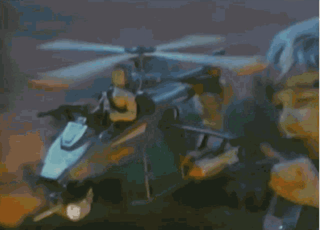 a boy playing with a toy helicopter that says rescue on the side
