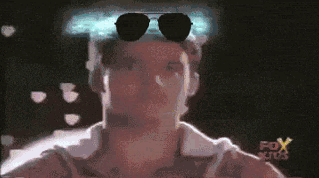 a pixelated image of a man wearing sunglasses and a fox kids logo on the bottom