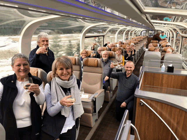 a group of people on a train toasting with glasses