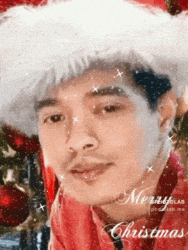 a man wearing a santa hat with the words merry christmas written on the bottom