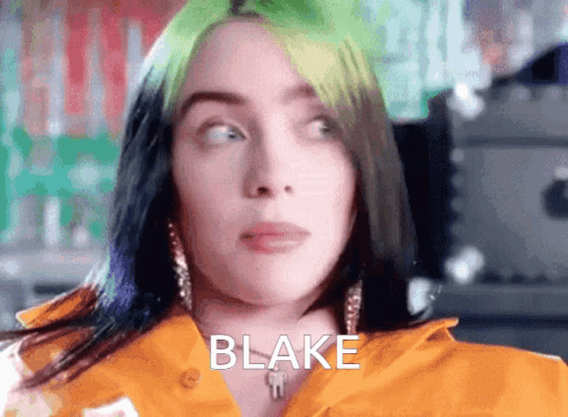 billie eilish is wearing a yellow shirt with blake written on the front