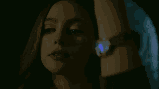 a close up of a woman wearing a watch