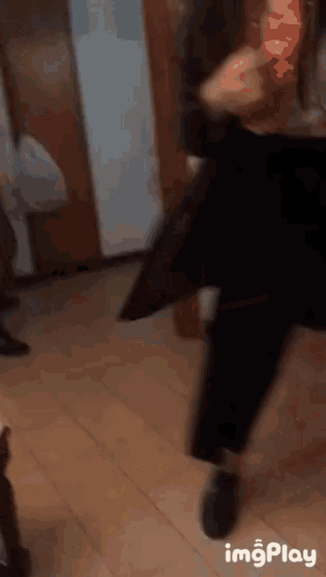 a blurred image of a person dancing with the words imgplay below it