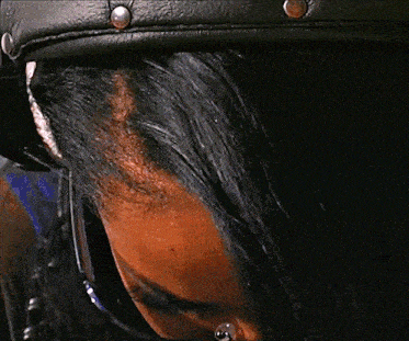 a close up of a woman 's face with a black mask on