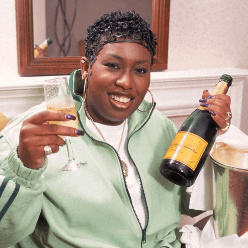 a woman in a green jacket is holding a bottle of veuve clicquot