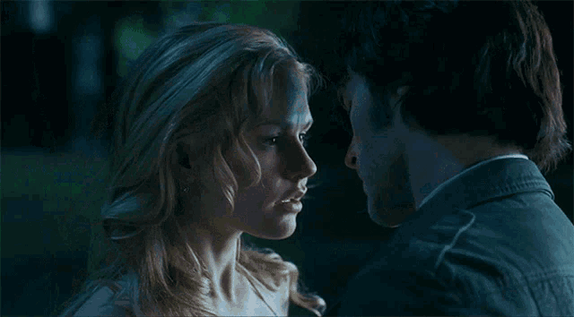a man and a woman are looking into each others eyes