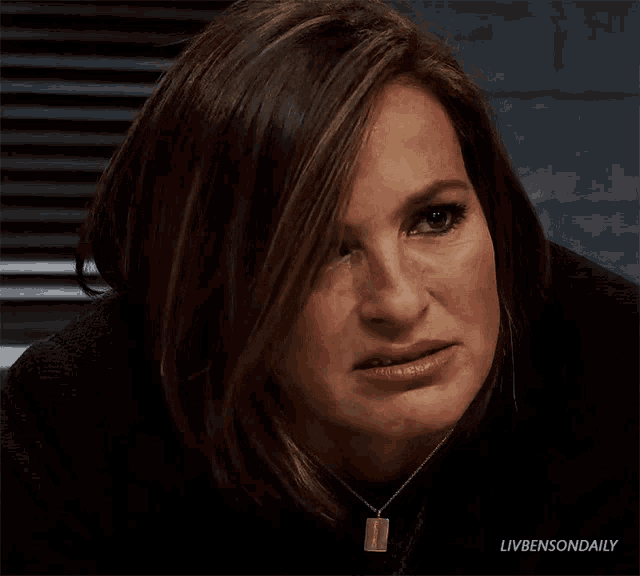 a close up of a woman wearing a black sweater and a necklace with the words livbensondaily on the bottom