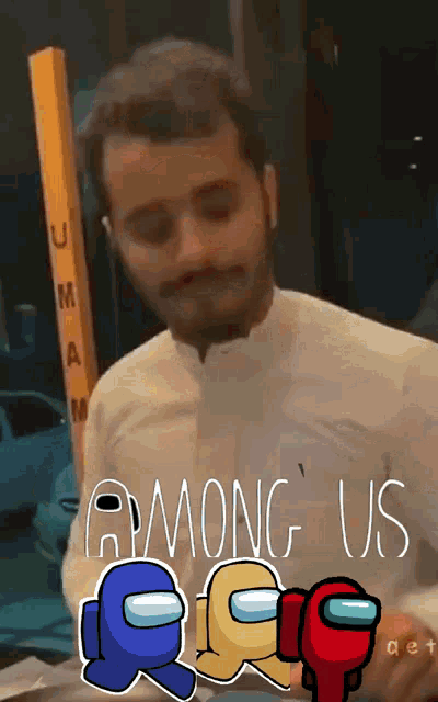 a man in a white shirt is standing in front of a sign that says " among us "