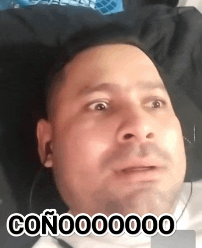 a man with a surprised look on his face has the word conoo00000 written on his face