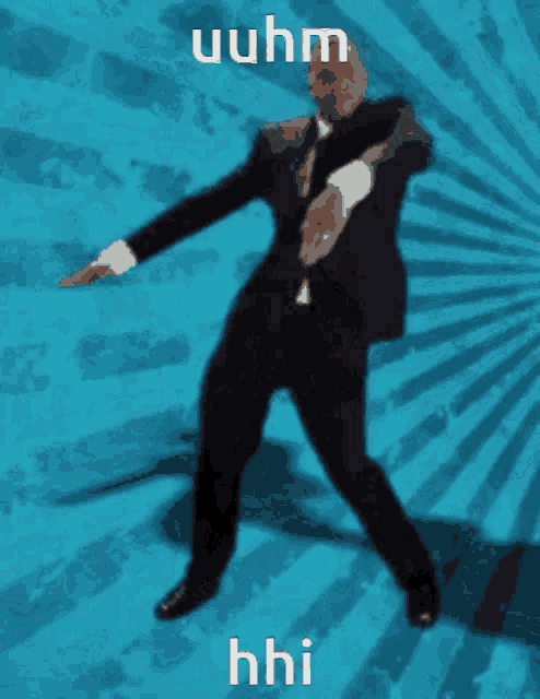 a man in a suit and tie is dancing in front of a blue background with the words " uuhm " on it