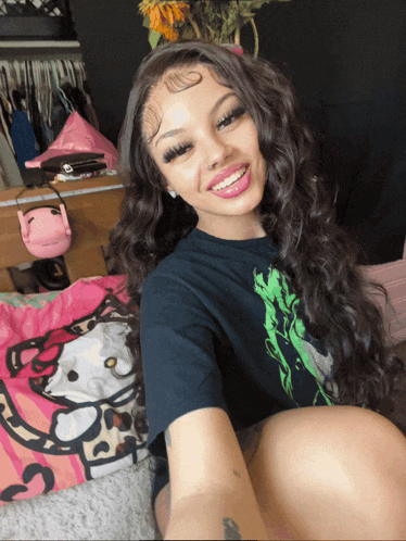 a girl with a hello kitty pillow in the background