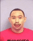 a man with a mustache is wearing a red t-shirt with the word mexico on it .