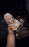 a woman is taking a picture of herself in a car .
