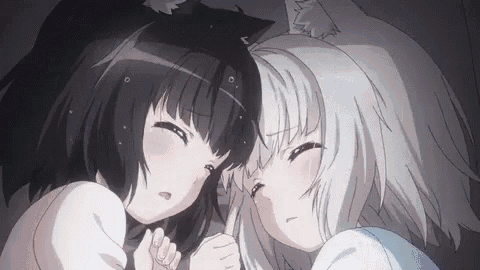 two anime girls , one black and one white , are laying next to each other in bed .