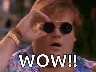 a man wearing sunglasses is looking through a pair of binoculars and says wow !