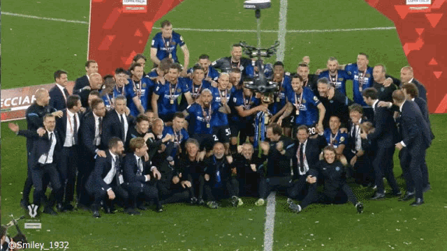 a group of soccer players are posing for a picture with a camera in front of a sign that says ' ecciaf