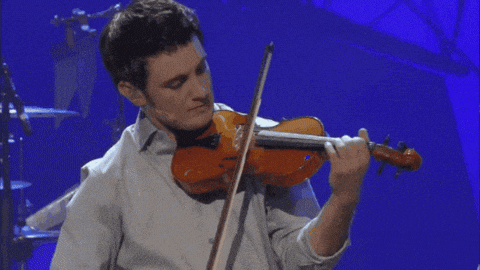 a man is playing a violin with a blue background