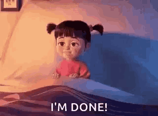 boo from monsters inc is sitting in a bed with the words `` i 'm done '' written on the bottom .
