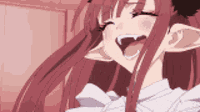 a close up of a girl with long red hair laughing with her mouth wide open .