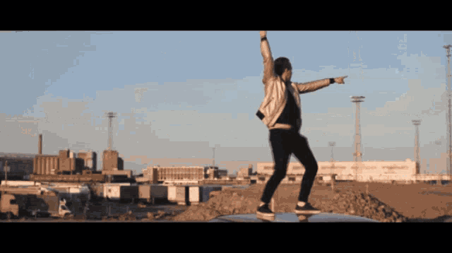 a man standing on a skateboard with his arms outstretched